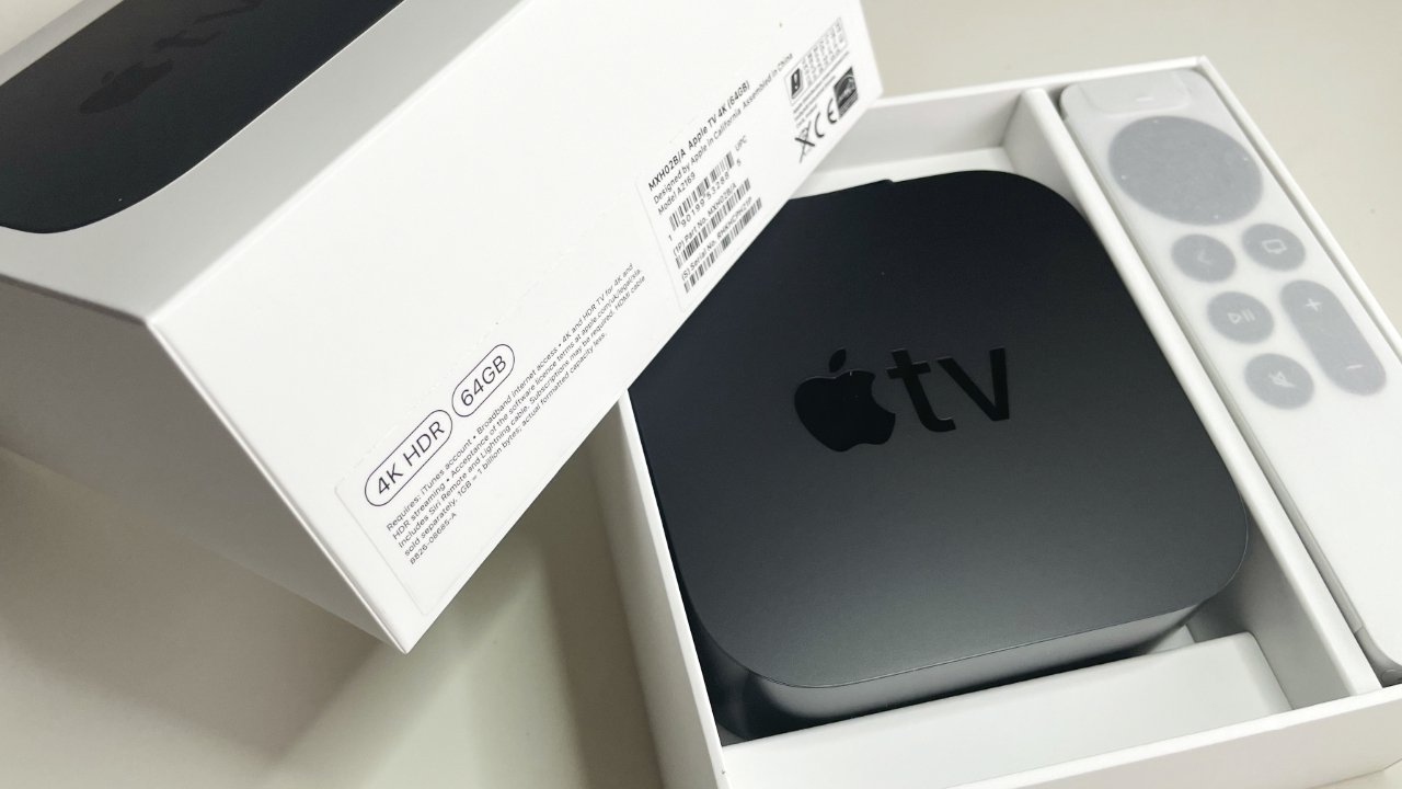 An open box containing a black Apple TV and its remote, with labels showing 4K HDR and 64GB features.