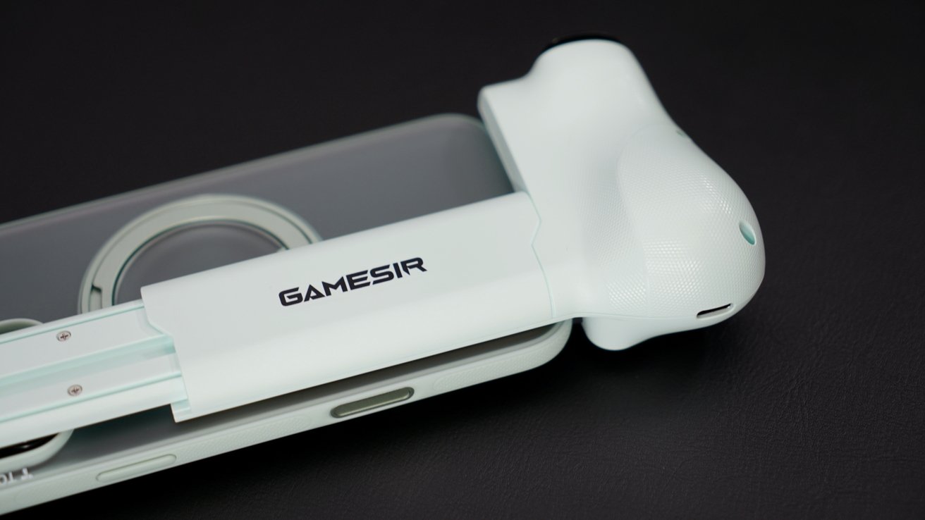 Light green GameSir controller partially attached to a smartphone resting on a black surface.
