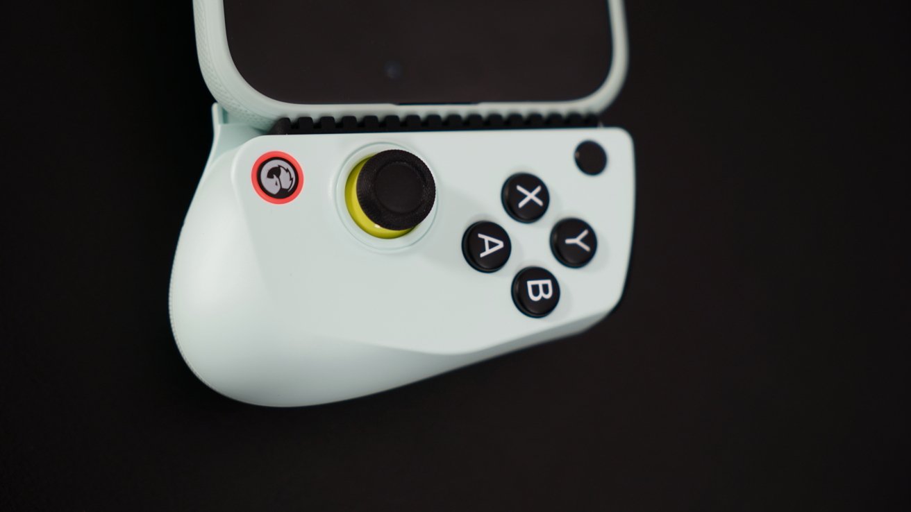 Light green game controller with black joystick, four black buttons labeled A, B, X, Y, and a small logo button on a black background.