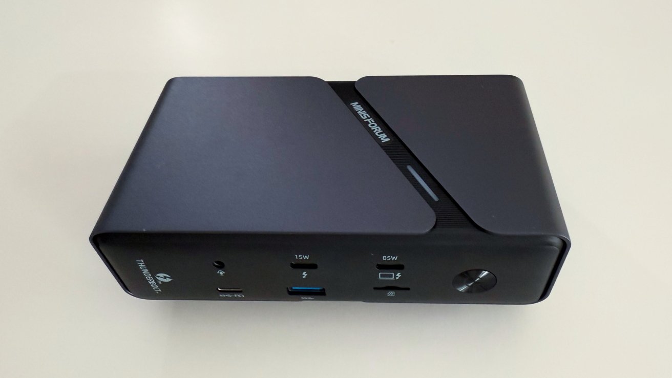 Black rectangular electronic device with USB ports, power button, and 'Thunderbolt' label, resting on a light surface.